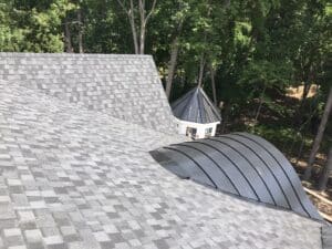 Roof installation for Patrick Joseph Distinctive Homes - CertainTeed Landmark Pro - Moire Black - Black standing seam metal roofing